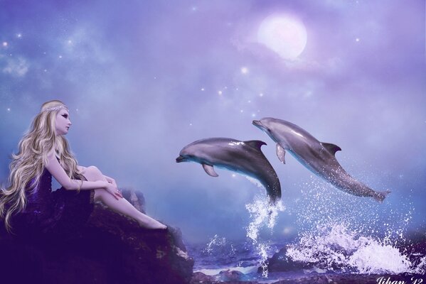 A girl and dolphins look at the sea