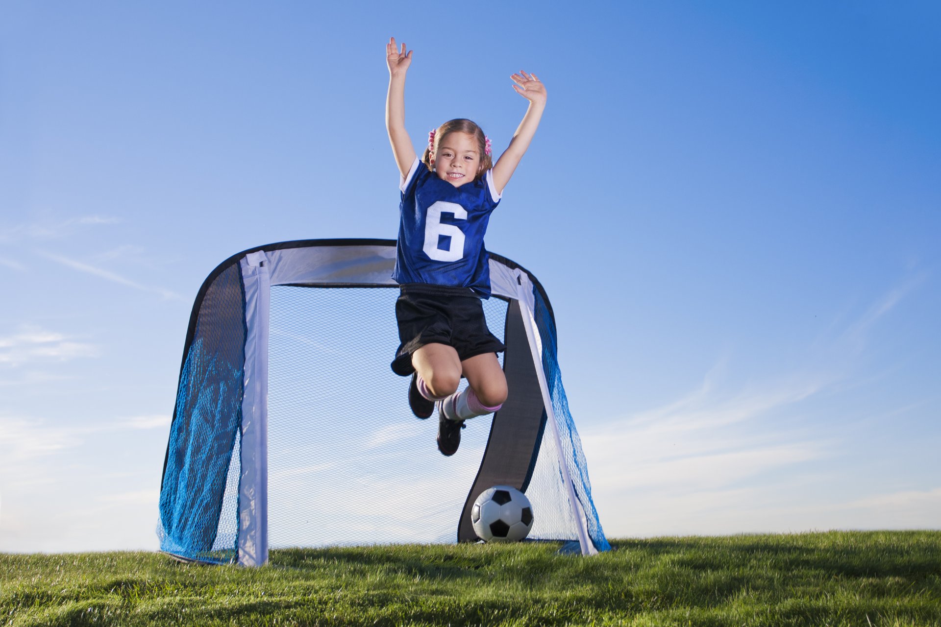 girl children ball the field sports football