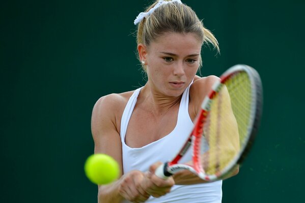 Photo of tennis player Camille Giorgi during a game of kicking a ball