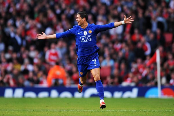 Ronaldo runs across the field with his arms outstretched