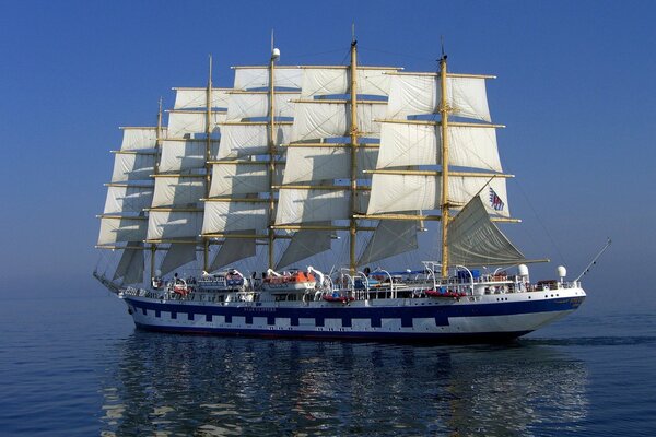 A sailboat plows the expanses of the seas