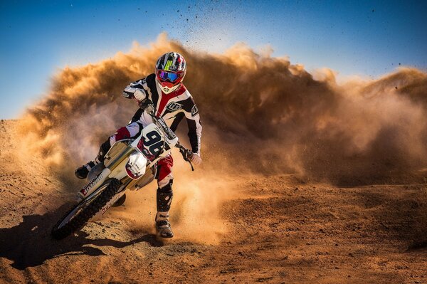 Dust rises after riding a motorcyclist