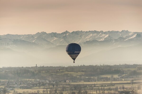 Blue and white balloon flying on the forest