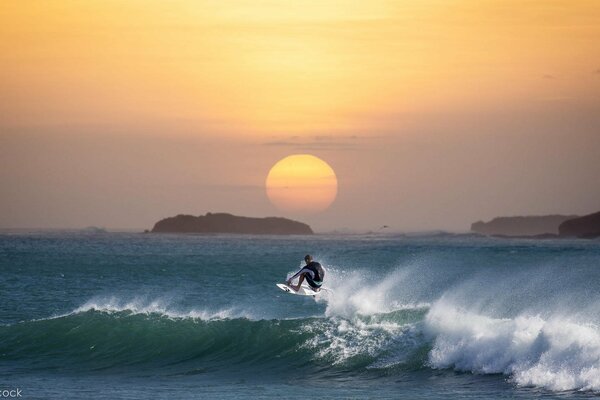 Exciting surfing in the sunset background