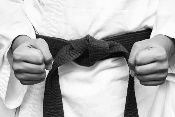 Black and white image of a karate kid with clenched fists