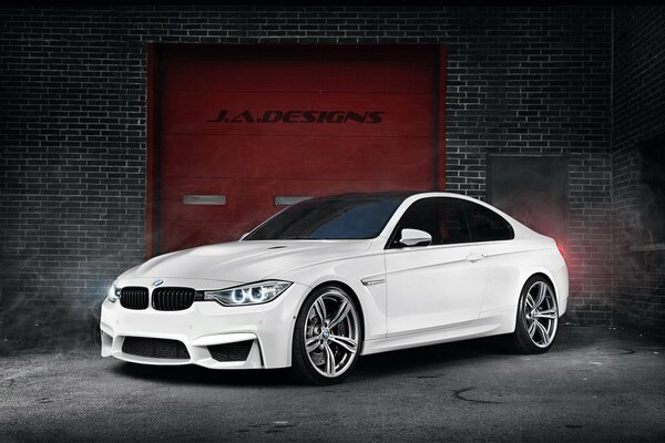 White BMW car at the garage gate