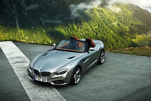 Convertible on the background of a green mountain