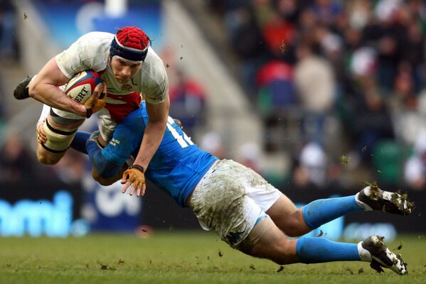 A game of rugby. Clash of two players