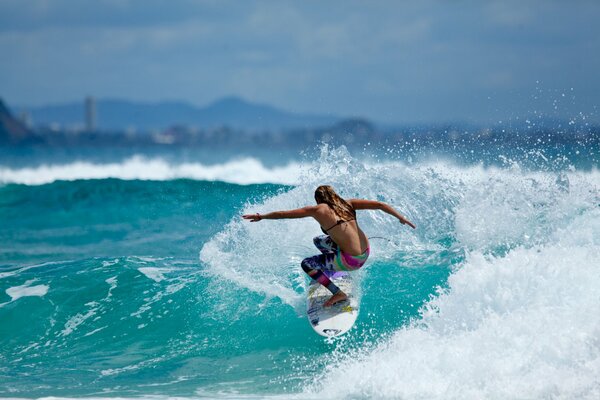 Ocean and sports, surfing on the water, waves for surfing, beautiful surfer