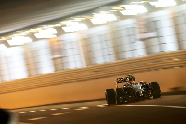 Racing car rides on the track