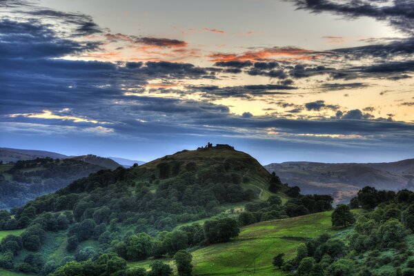 Hills overgrown with forest at sunset