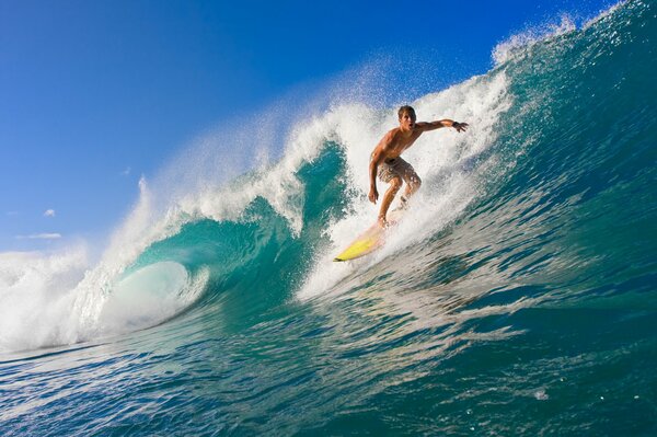 Man surfer on waves with foam