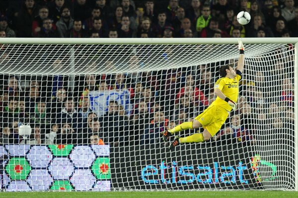 Photo of the goalkeeper in flight behind the ball