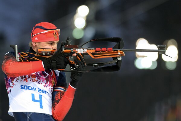 Belt photo of biathlete Anton Shipulin aiming a rifle during the competition at the Sochi 2014 Winter Olympics