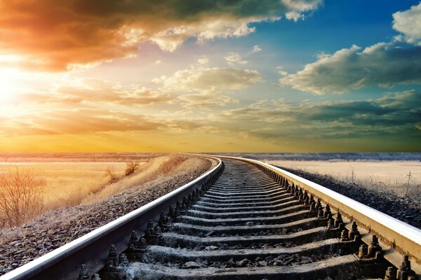 Railway on the background of the sky with clouds wallpaper