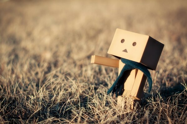 Cardboard man on dry grass. paperboard