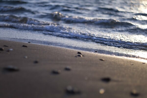 Plage de sable et la mer avec les reflets du soleil