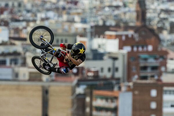 Cyclist in helmet demonstrates jump