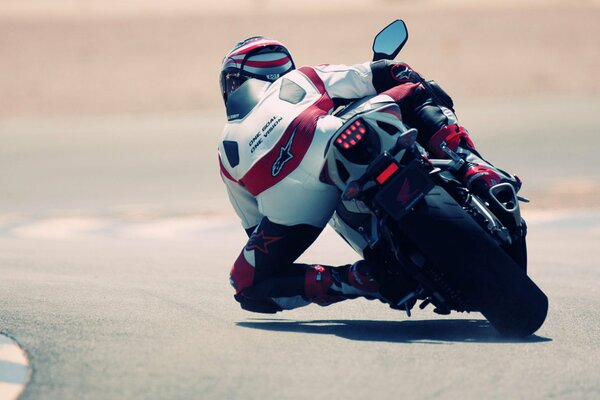 A motorcyclist enters a sharp turn