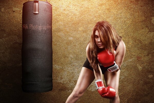 Athletic girl boxer in training