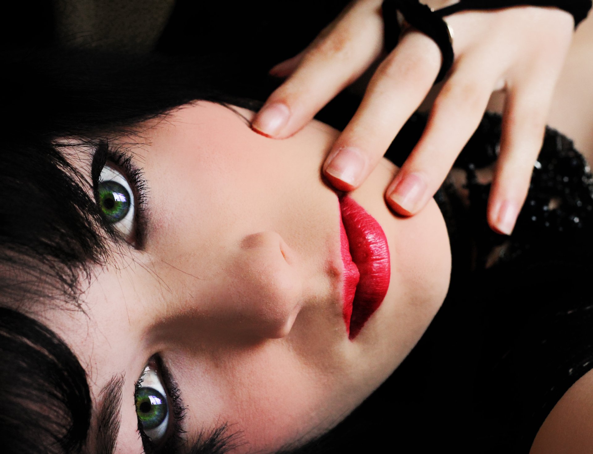 girl green eyes make-up red lips hair black hand