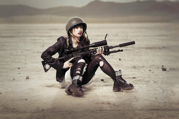 A girl in a helmet and with a gun in her hands