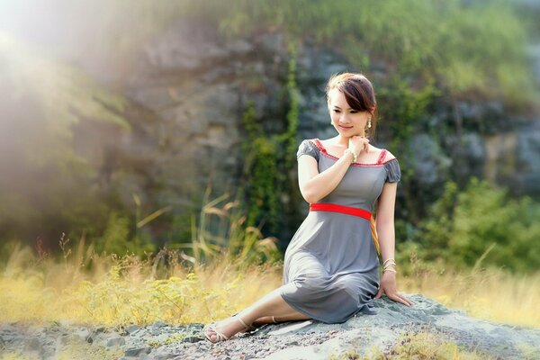 Beautiful girl sitting on the rocks