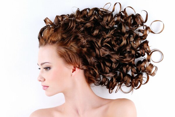 Fille avec une coiffure de boucles sur fond blanc