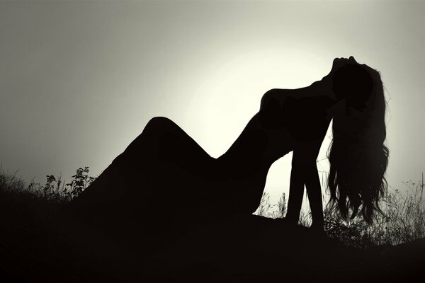 Silhouette of a girl against the sunset