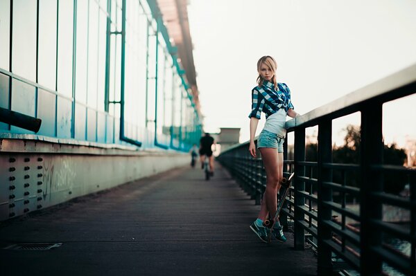 Slender girl on the city bridge