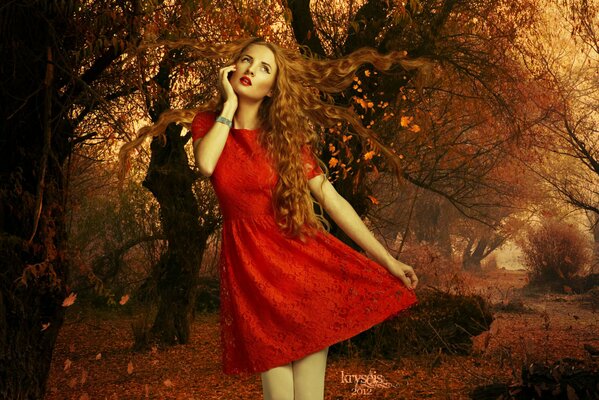 A girl in a red dress with red lips on the background of autumn