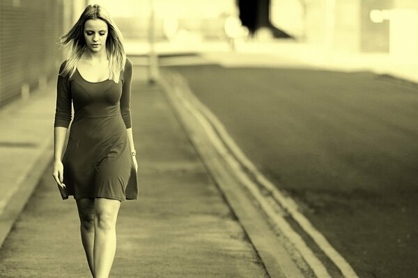 Una chica con un vestido camina por las calles de la ciudad