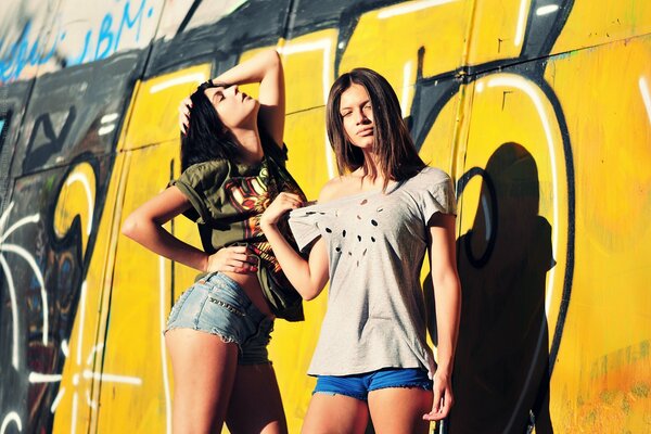 Photo of girls on a graffiti wall background