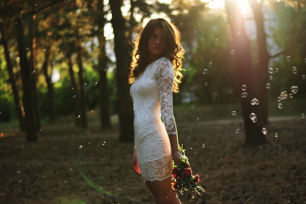 A girl in a dress with a bouquet