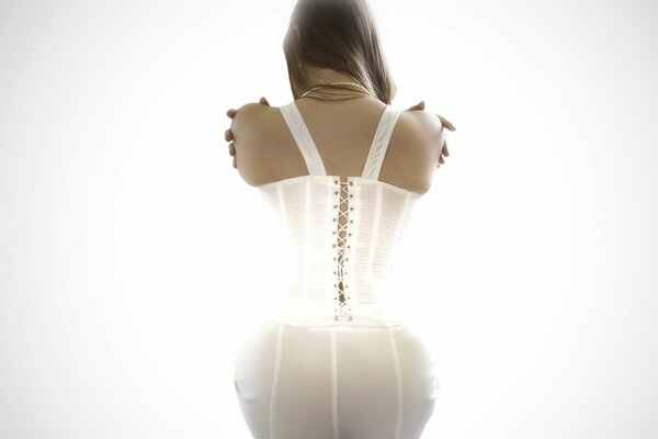 A girl in a corset with her back turned