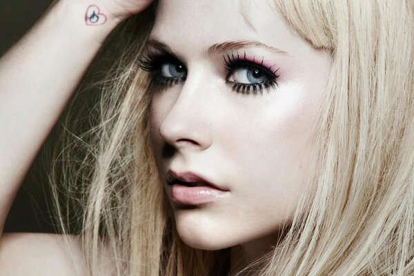 Avril Lavigne s face close-up on a dark background