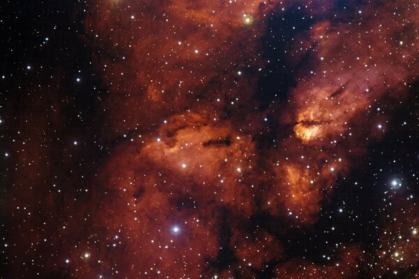 A star cluster on the background of a nebula in fiery black tones