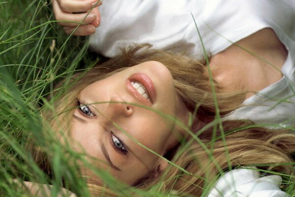 The look of a girl in a white T-shirt in the grass