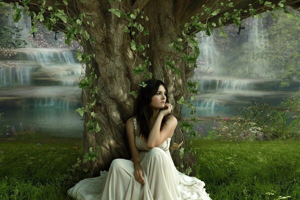 A girl under a tree in a white dress