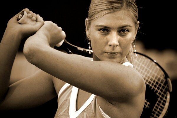 Maria Sharapova with a tennis racket in her hands