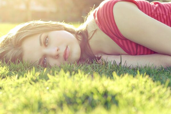 Beautiful girl lying on the grass