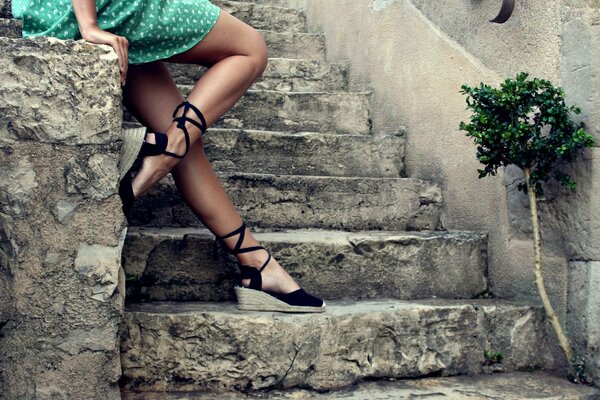 Women s feet on a stone staircase