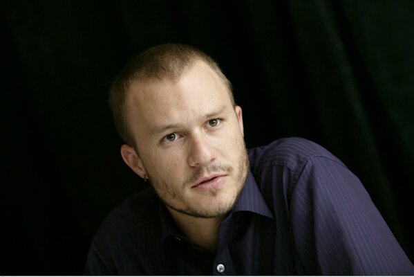 Actor Heath Ledger on a dark background