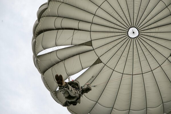 A soldier flying down on a parachute