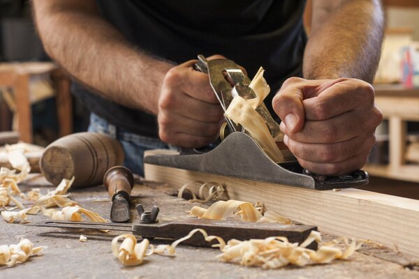 The worker processes the tree with special tools