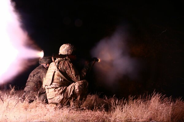 Soldiers make a shot at night