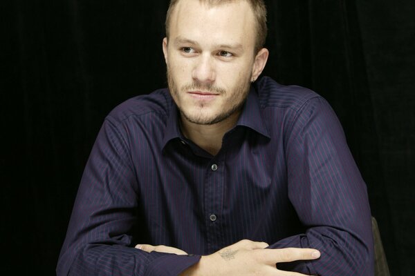 Actor Heath Ledger in a shirt with stubble