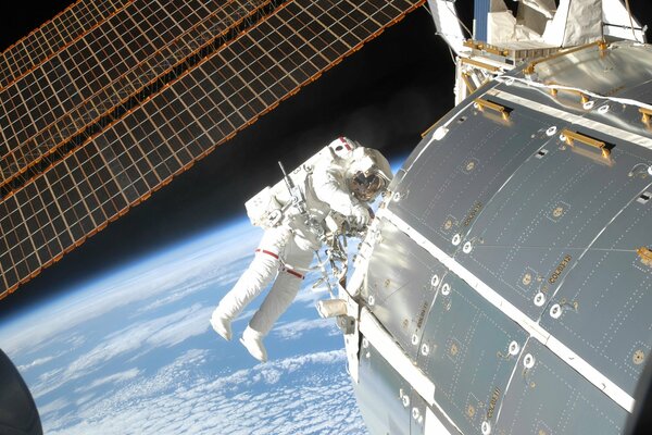 An astronaut in outer space against the background of the earth