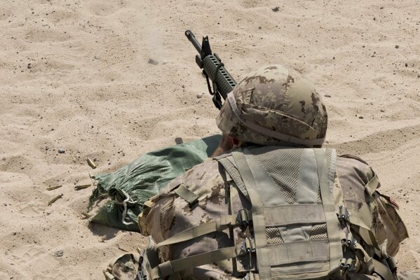 Canadian Army and armed saldat on the sand