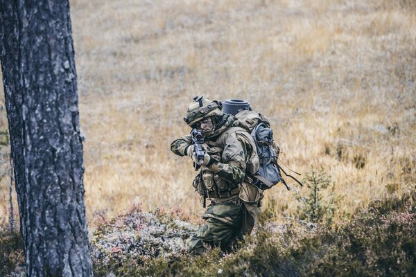 A Norwegian soldier holds a gun at gunpoint